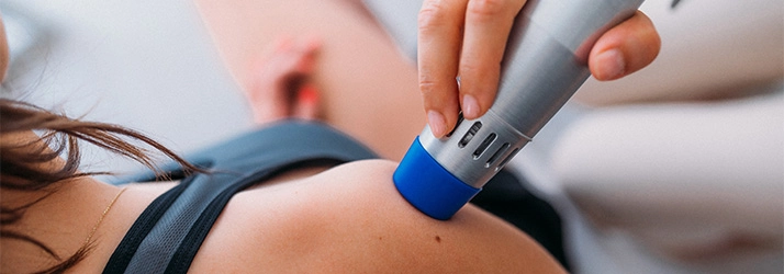 Chiropractic Auburn WA Cold Laser Therapy A patient with a cold laser therapy wand on their c\shoulder.